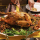 Person carving traditional Thanksgiving turkey